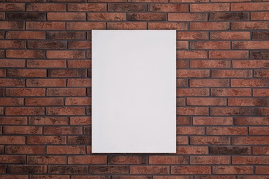Image of Blank poster on brick wall. Mockup for design 