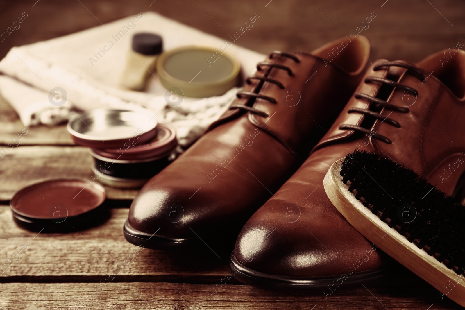 Image of Shoe care accessories and footwear on wooden background