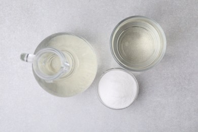 Vinegar and baking soda on light table, flat lay