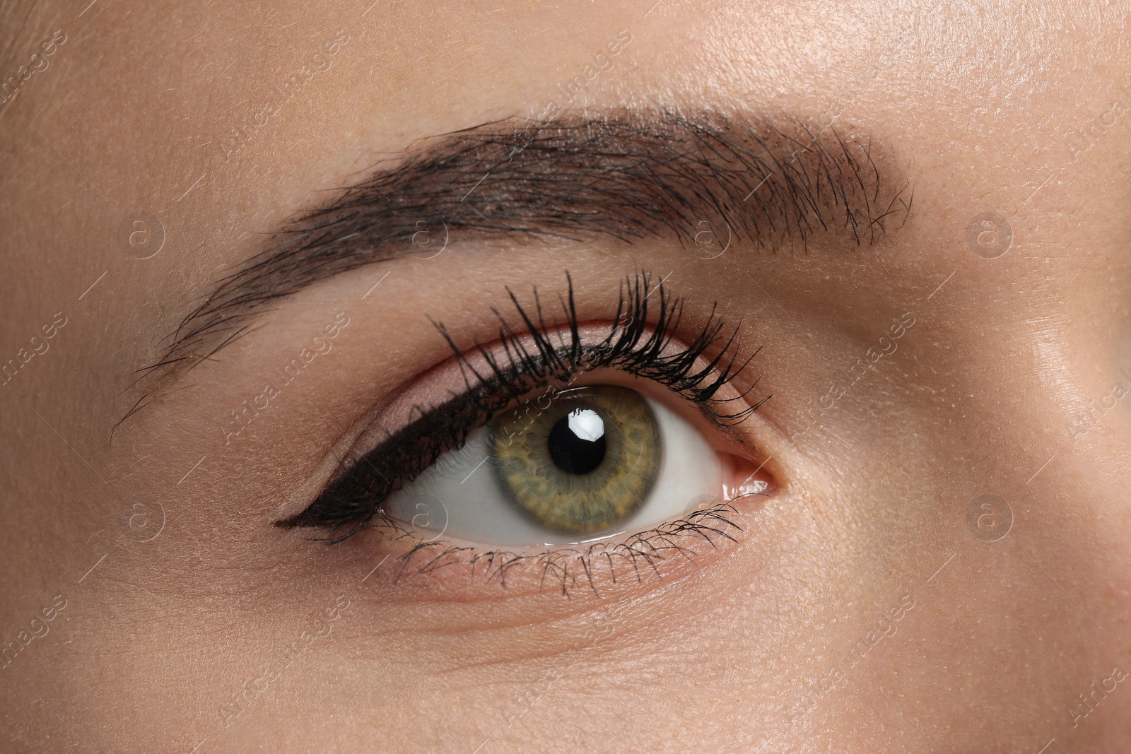 Photo of Young woman with permanent makeup of eyes and brows, closeup