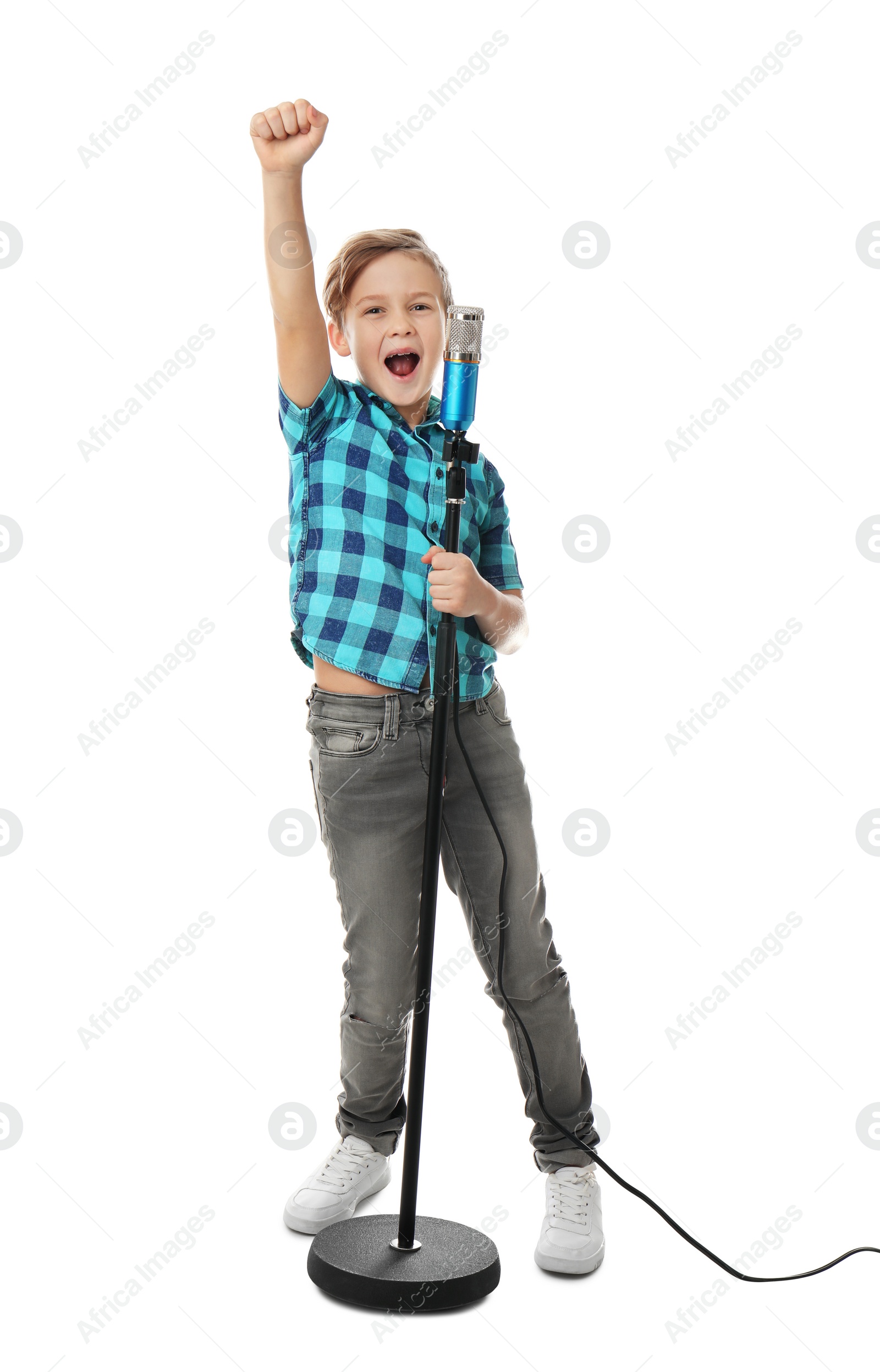 Photo of Cute boy singing in microphone on white background