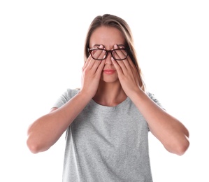 Young woman covering eyes with hands on white background