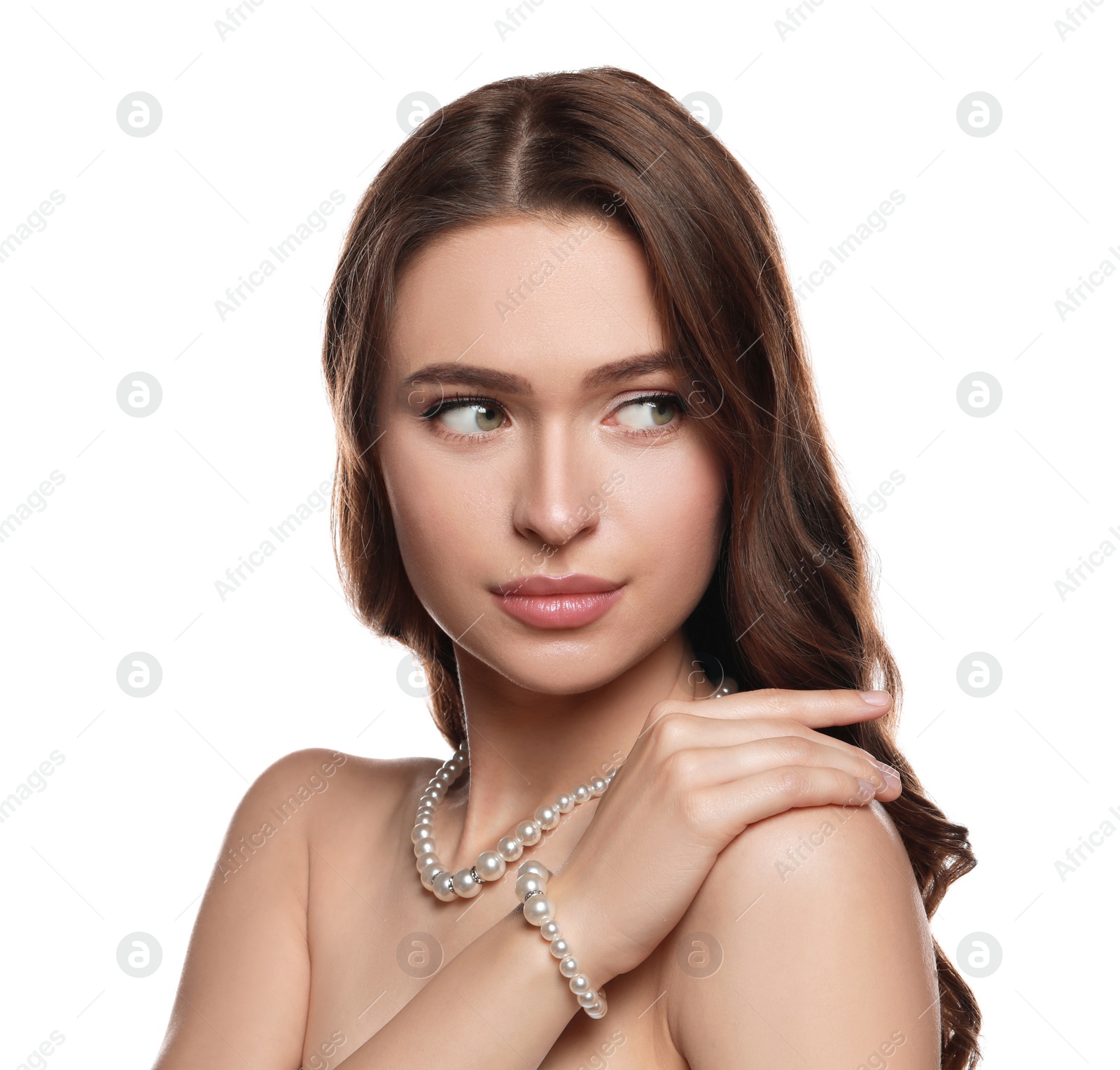 Photo of Young woman wearing elegant pearl jewelry on white background