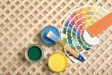 Photo of Different paints with brush and palette on wooden background, flat lay