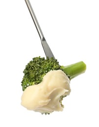 Photo of Tasty fondue. Fork with broccoli and melted cheese isolated on white