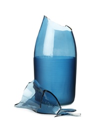 Broken blue glass vase isolated on white