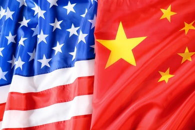 Photo of USA and China flags as background, top view. International relations