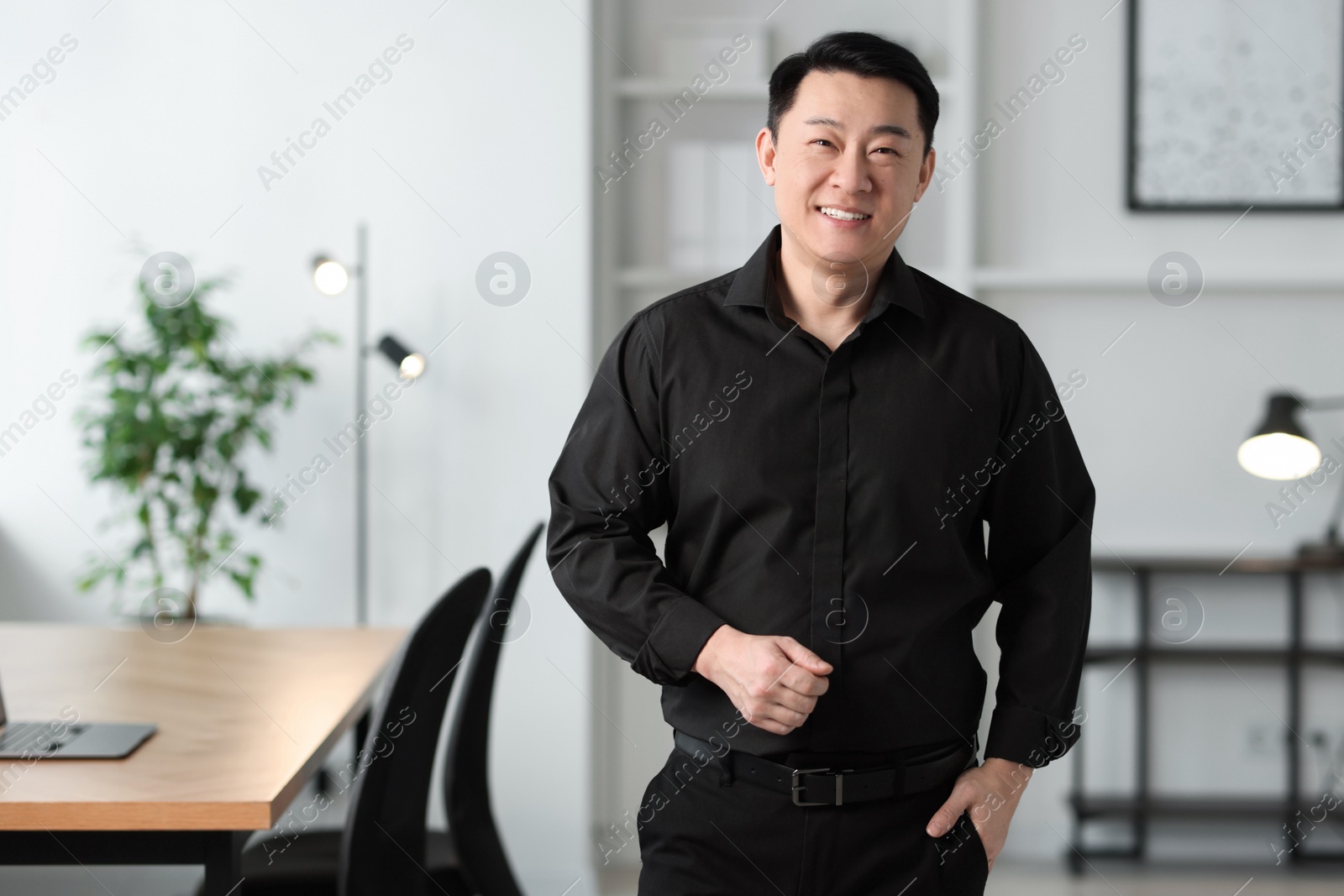 Photo of Portrait of smiling businessman in office. Space for text