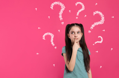 Image of Emotional girl with drawings of question marks on pink background