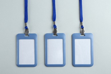 Blank badges on light background, flat lay. Mockup for design