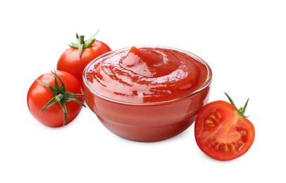 Photo of Tasty ketchup in glass bowl and fresh tomatoes isolated on white