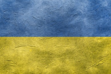 Image of National flag of Ukraine painted on textured surface