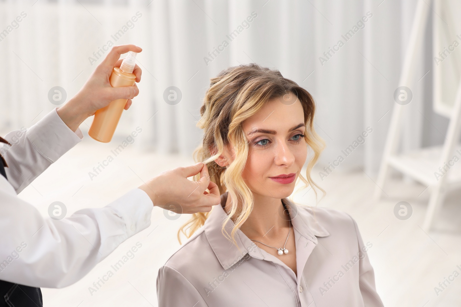 Photo of Hair styling. Professional hairdresser working with client indoors, closeup