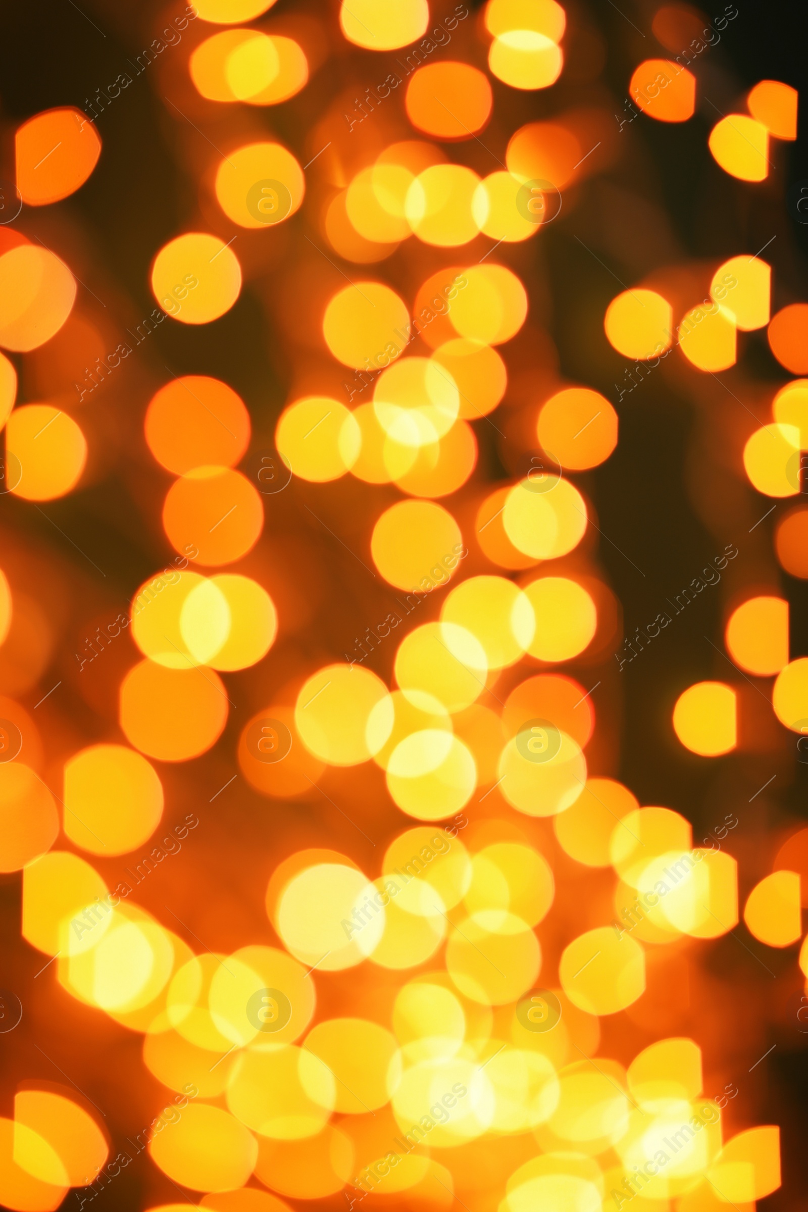 Photo of Beautiful gold lights on dark background. Bokeh effect