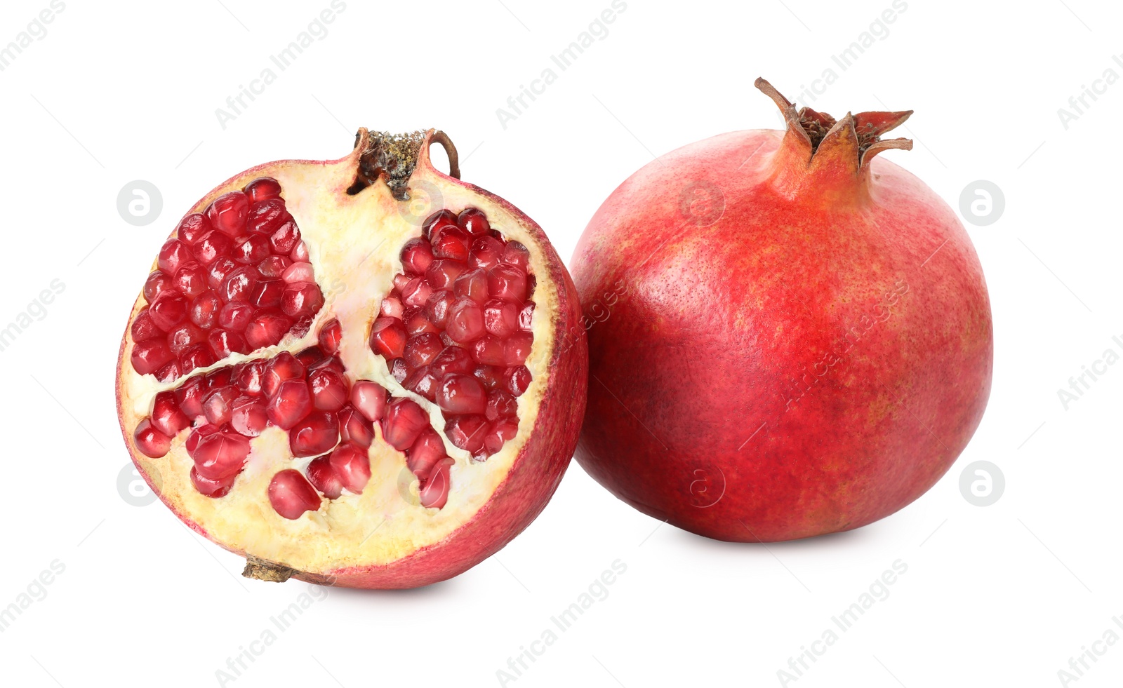 Photo of Half and whole pomegranates isolated on white