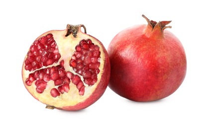 Half and whole pomegranates isolated on white