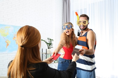 Photo of Beautiful young couple visiting travel agency office