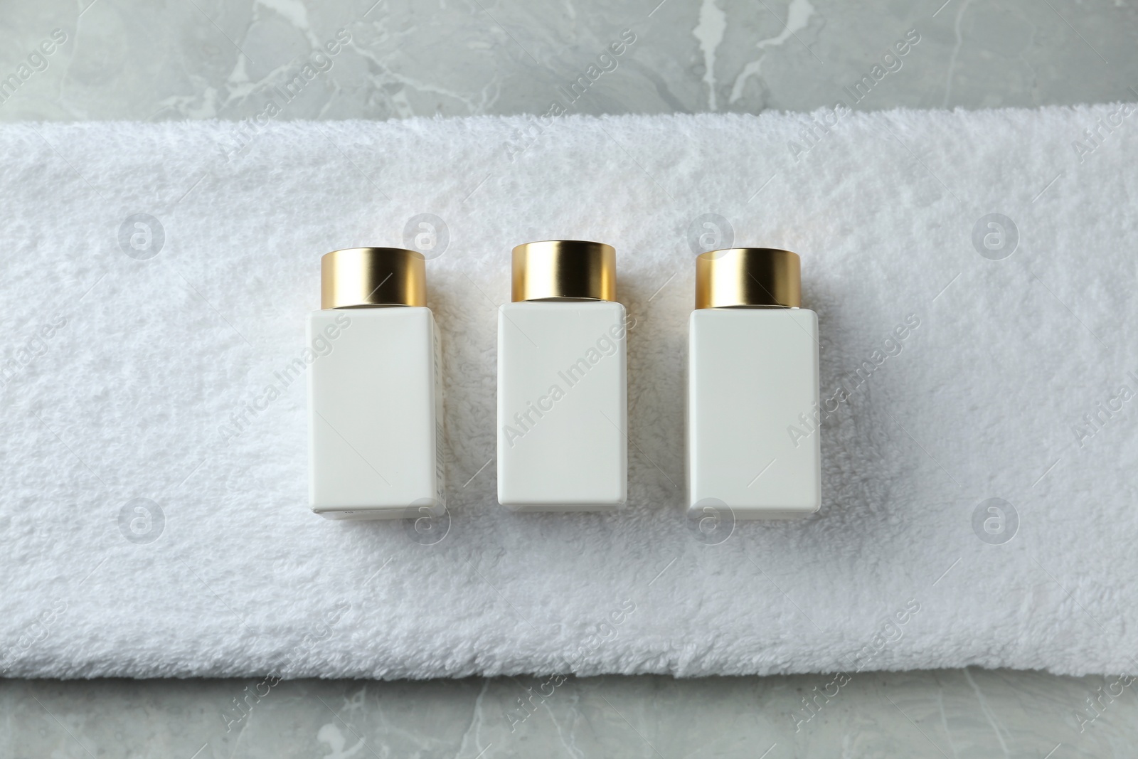 Photo of Composition with cosmetic products on grey stone table, flat lay. Spa therapy