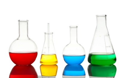 Different laboratory glassware with colorful liquids isolated on white
