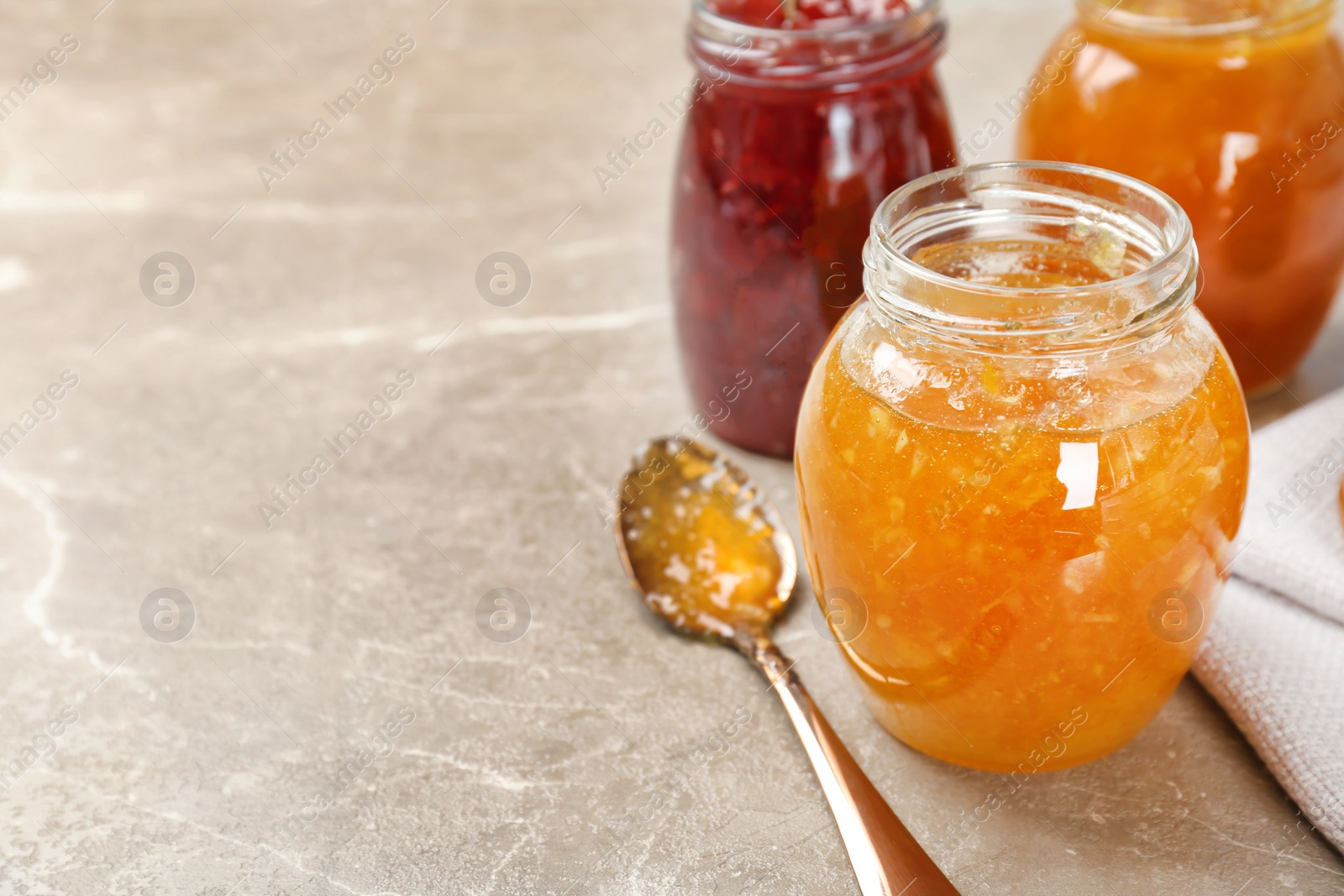 Photo of Jars with different sweet jam on table