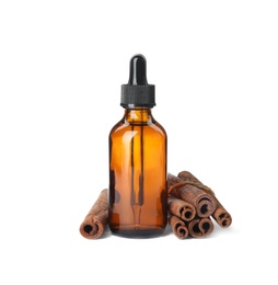 Photo of Bottle of essential oil and cinnamon sticks on white background