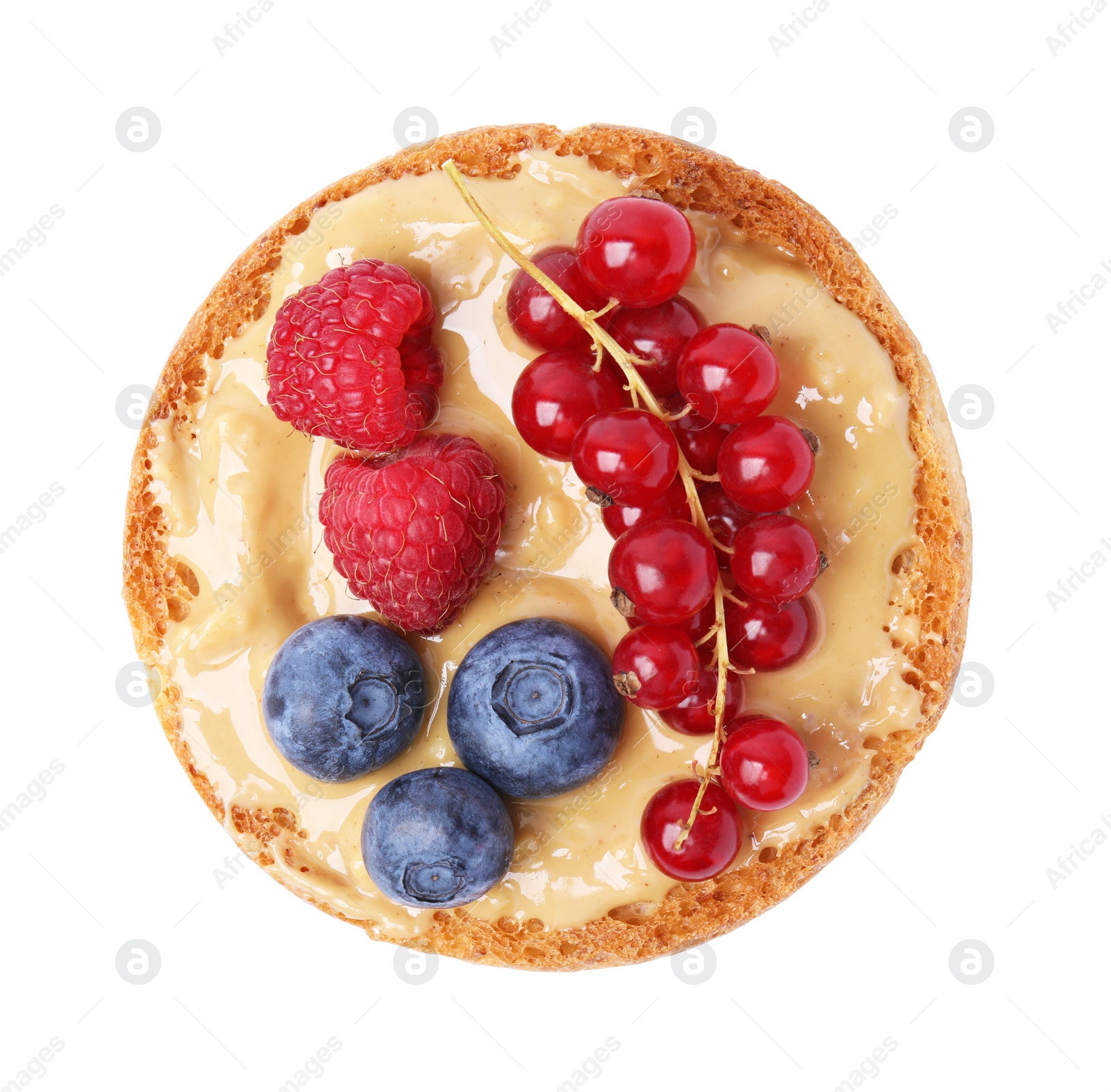 Photo of Tasty organic rusk with peanut butter and sweet berries isolated on white, top view