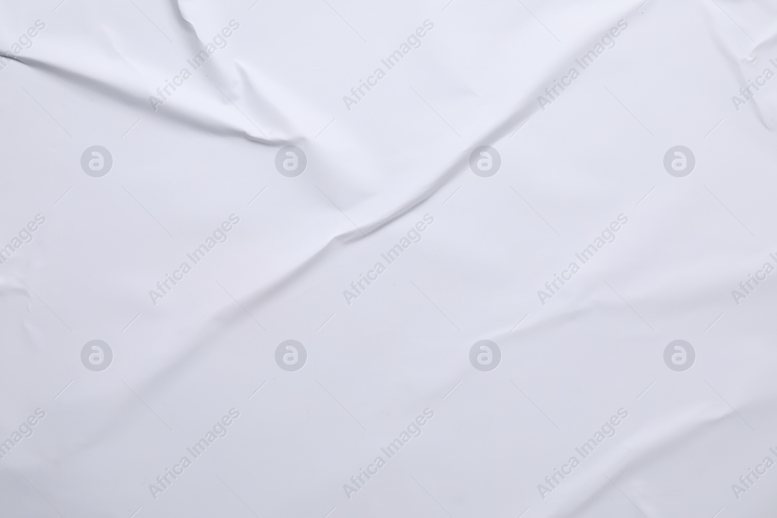 Photo of White crumpled sheet of paper as background, top view. Wall poster