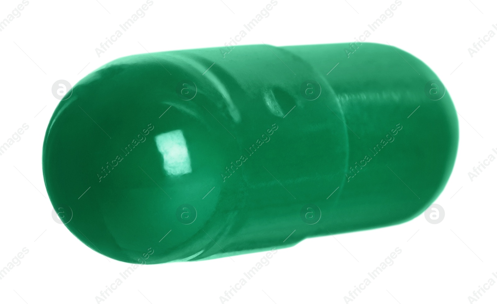 Photo of One green pill on white background. Medicinal treatment