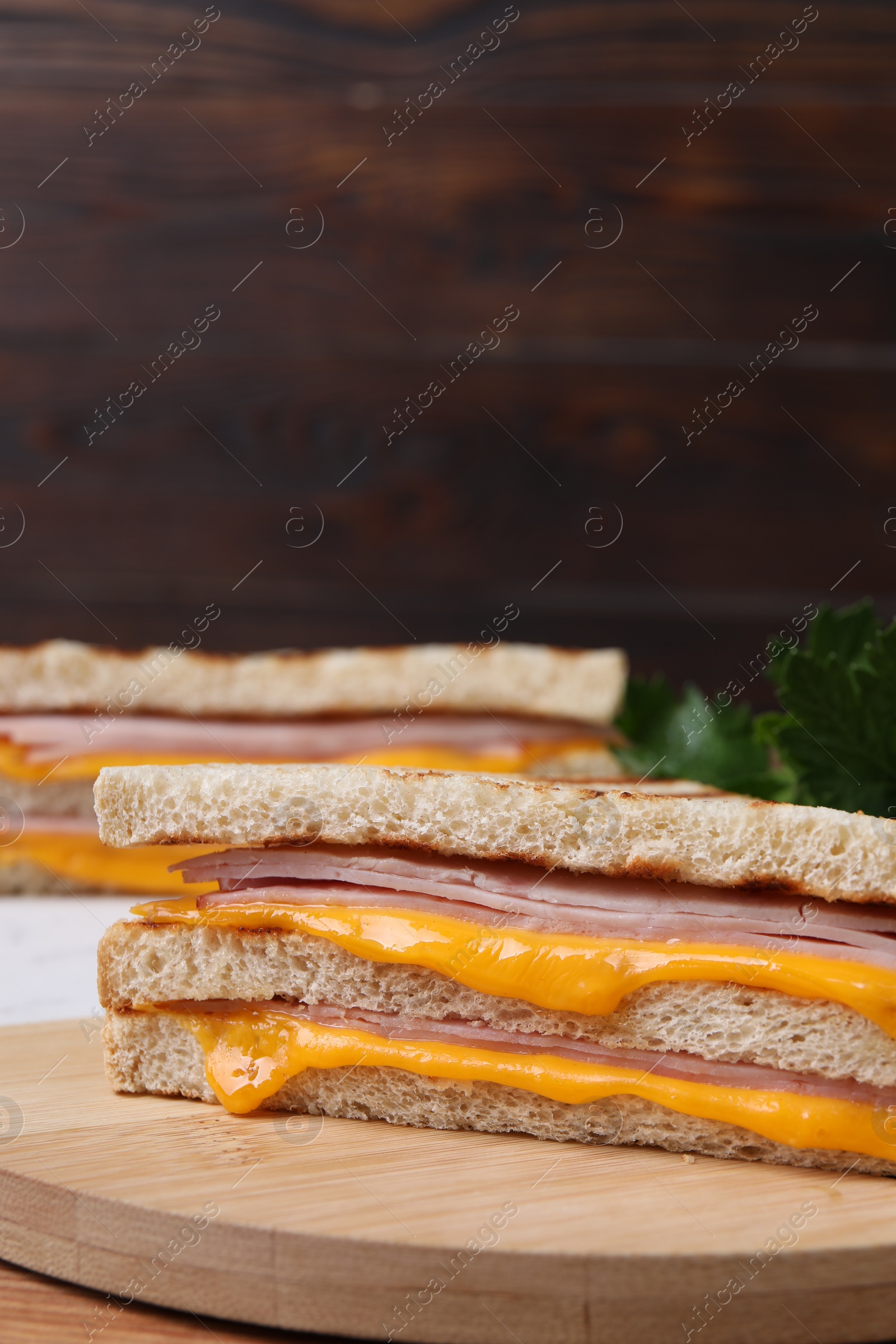 Delicious grilled sandwiches with ham and cheese on table, closeup Photo of Delicious grilled sandwiches with ham and cheese on table, closeup