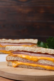 Photo of Delicious grilled sandwiches with ham and cheese on table, closeup