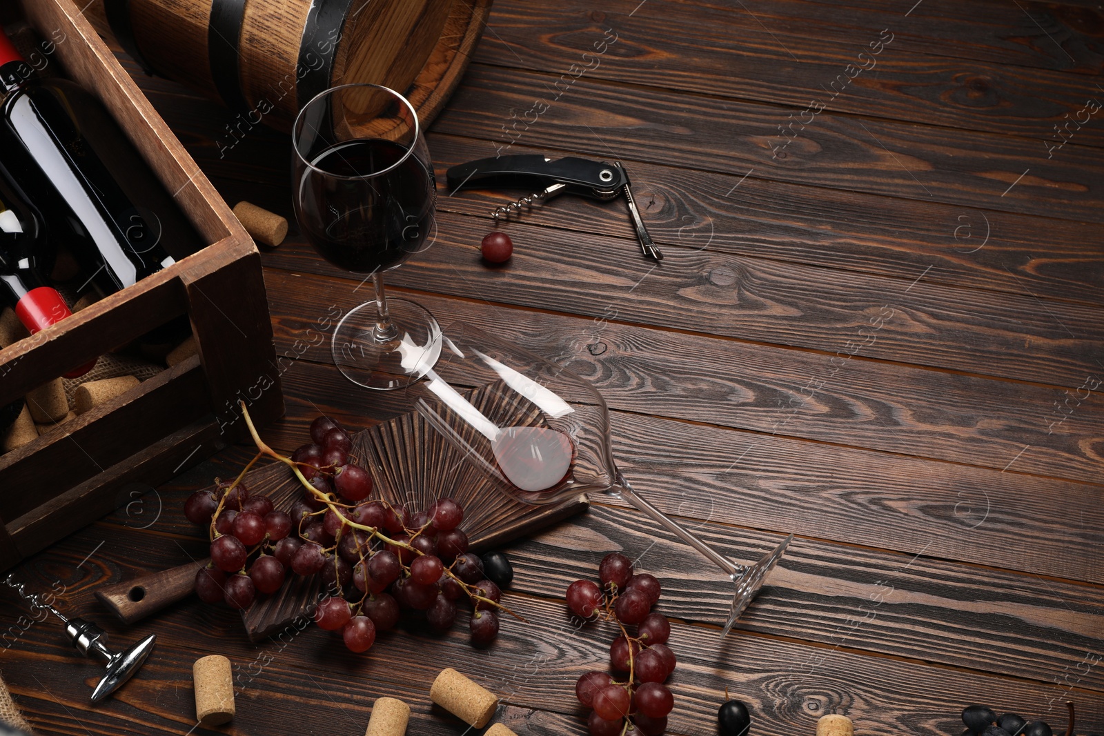 Photo of Winemaking. Composition with tasty wine and barrel on wooden table, above view. Space for text