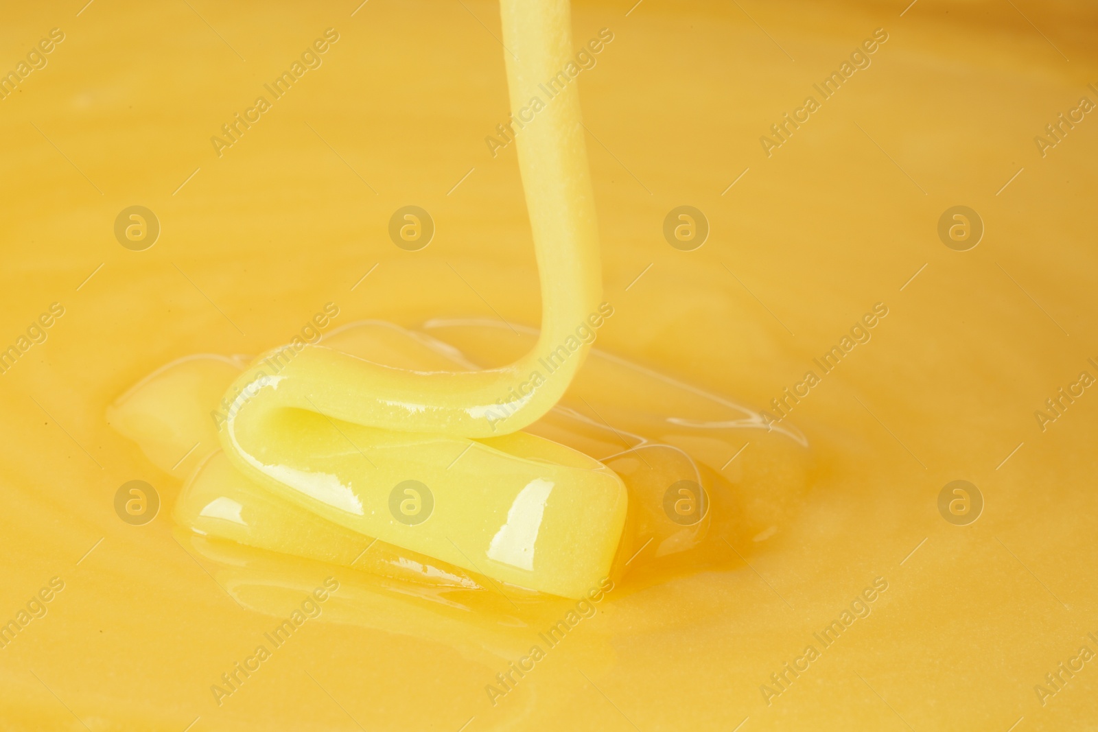 Photo of Pouring fresh sweet honey, closeup