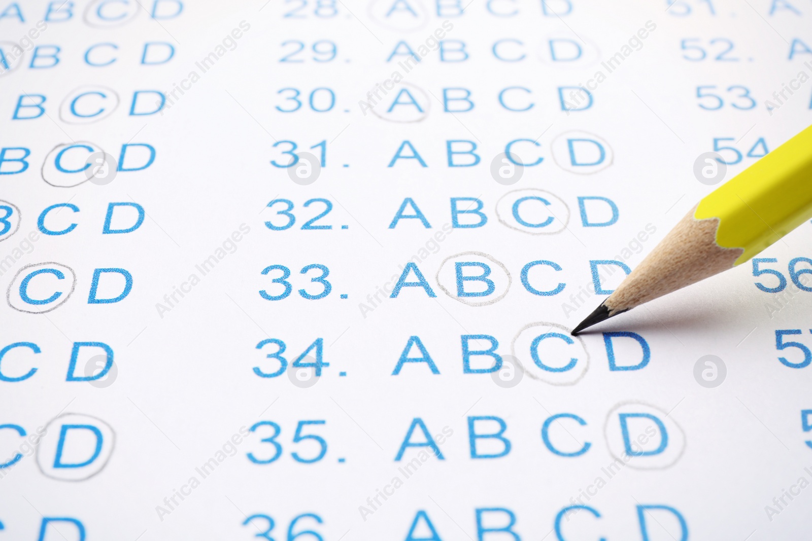 Photo of Filling answer sheet with pencil, closeup view