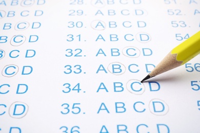 Photo of Filling answer sheet with pencil, closeup view