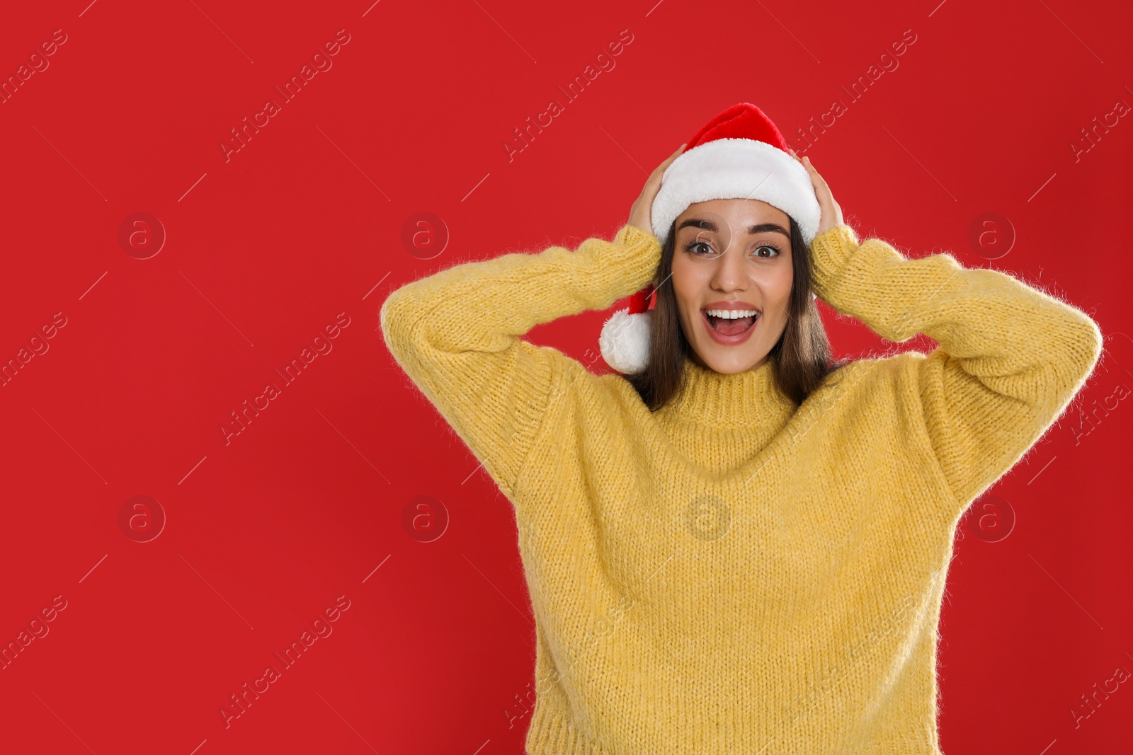 Photo of Excited woman in Santa hat on red background, space for text. Christmas countdown