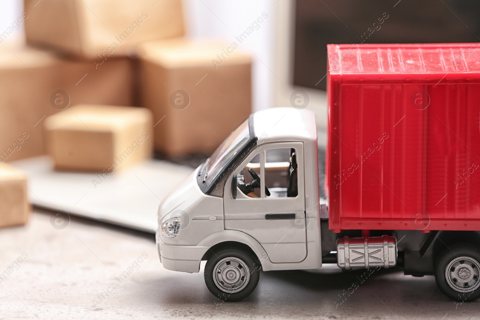 Photo of Toy truck on table. Logistics and wholesale concept