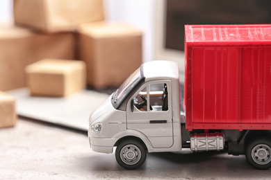 Photo of Toy truck on table. Logistics and wholesale concept