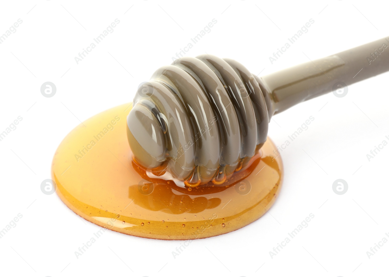 Photo of Delicious honey and dipper on white background