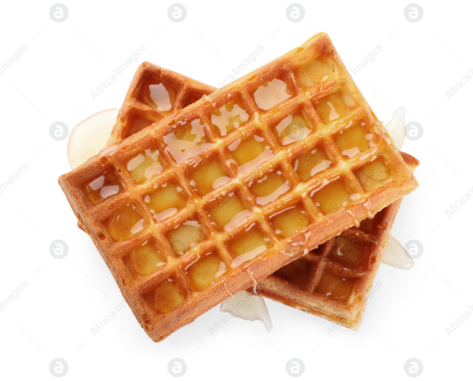 Photo of Delicious Belgian waffles with honey on white background, top view