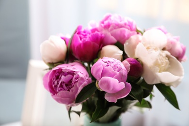 Photo of Bouquet of beautiful peonies in room, closeup