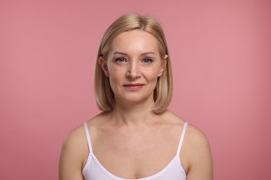 Photo of Beautiful woman with healthy skin on pink background