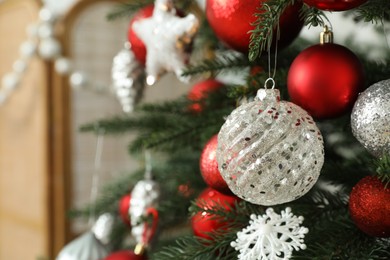 Closeup view of beautifully decorated Christmas tree indoors, space for text