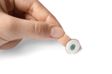 Woman putting sticking plaster on white background. First aid item