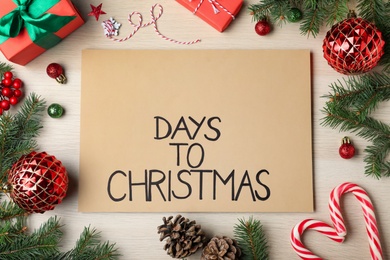 Flat lay composition of card with words Days To Christmas and space for text on wooden table. Holiday countdown