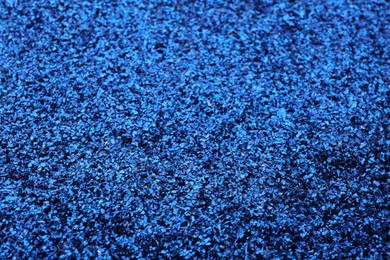 Photo of Beautiful shiny blue glitter as background, closeup