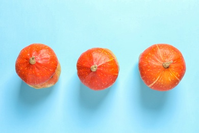 Photo of Flat lay composition with orange pumpkins on color background. Autumn holidays