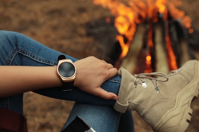 Photo of Woman with stylish smart watch outdoors, closeup
