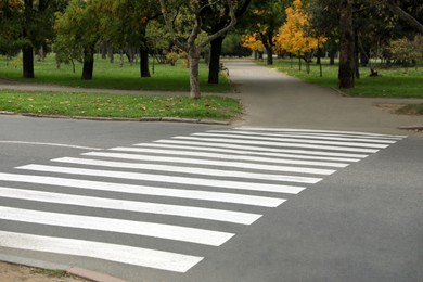 Photo of Pedestrian crossing on empty city street in autumn