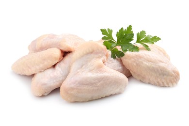 Photo of Raw chicken wings with parsley on white background