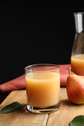 Photo of Fresh pear juice in glass and fruit on wooden table